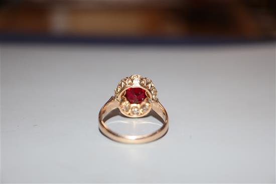 An early-mid 20th century yellow metal, red doublet and diamond set oval cluster ring, size K, gross 4.4 grams.